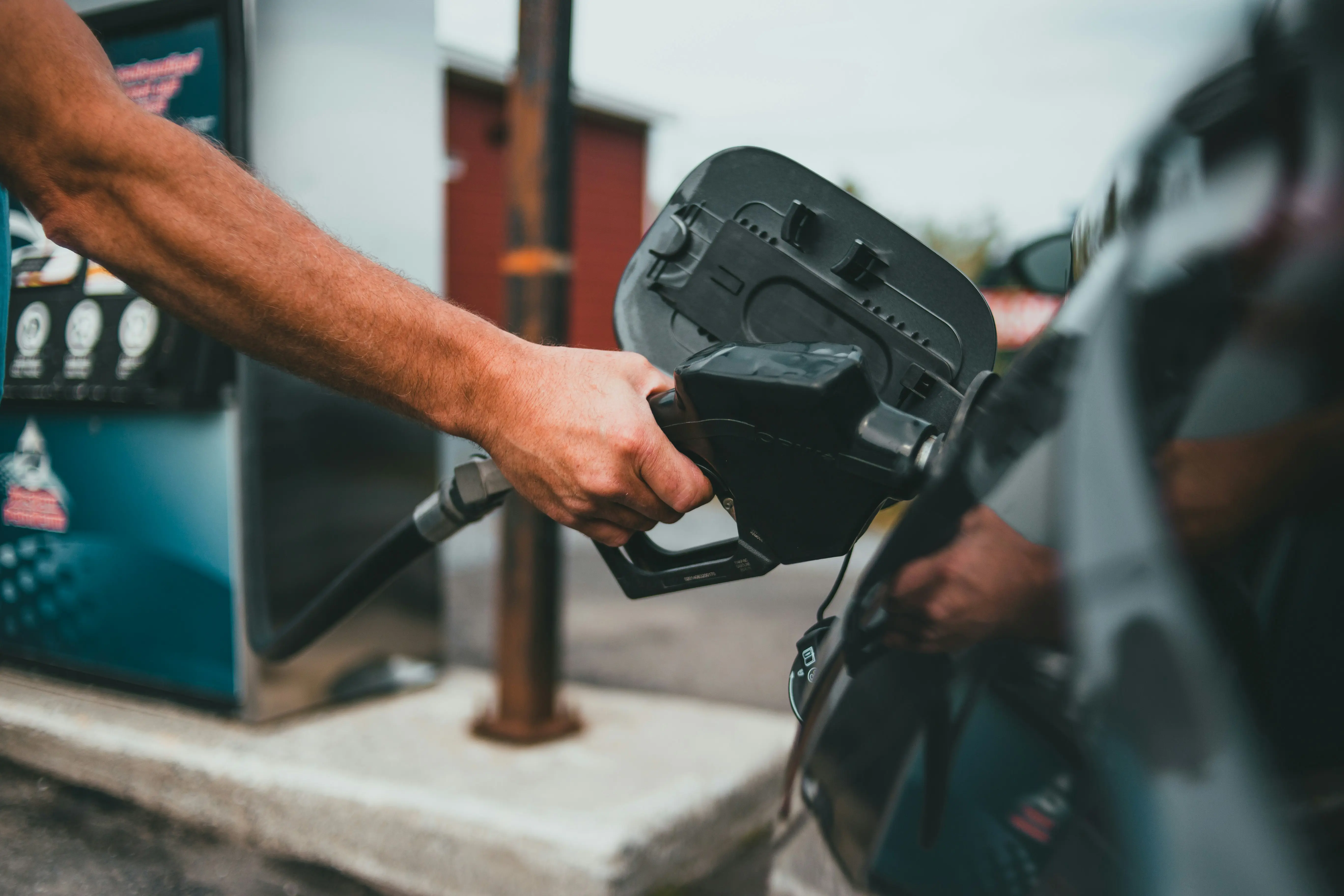 Person refueling a car with petrol