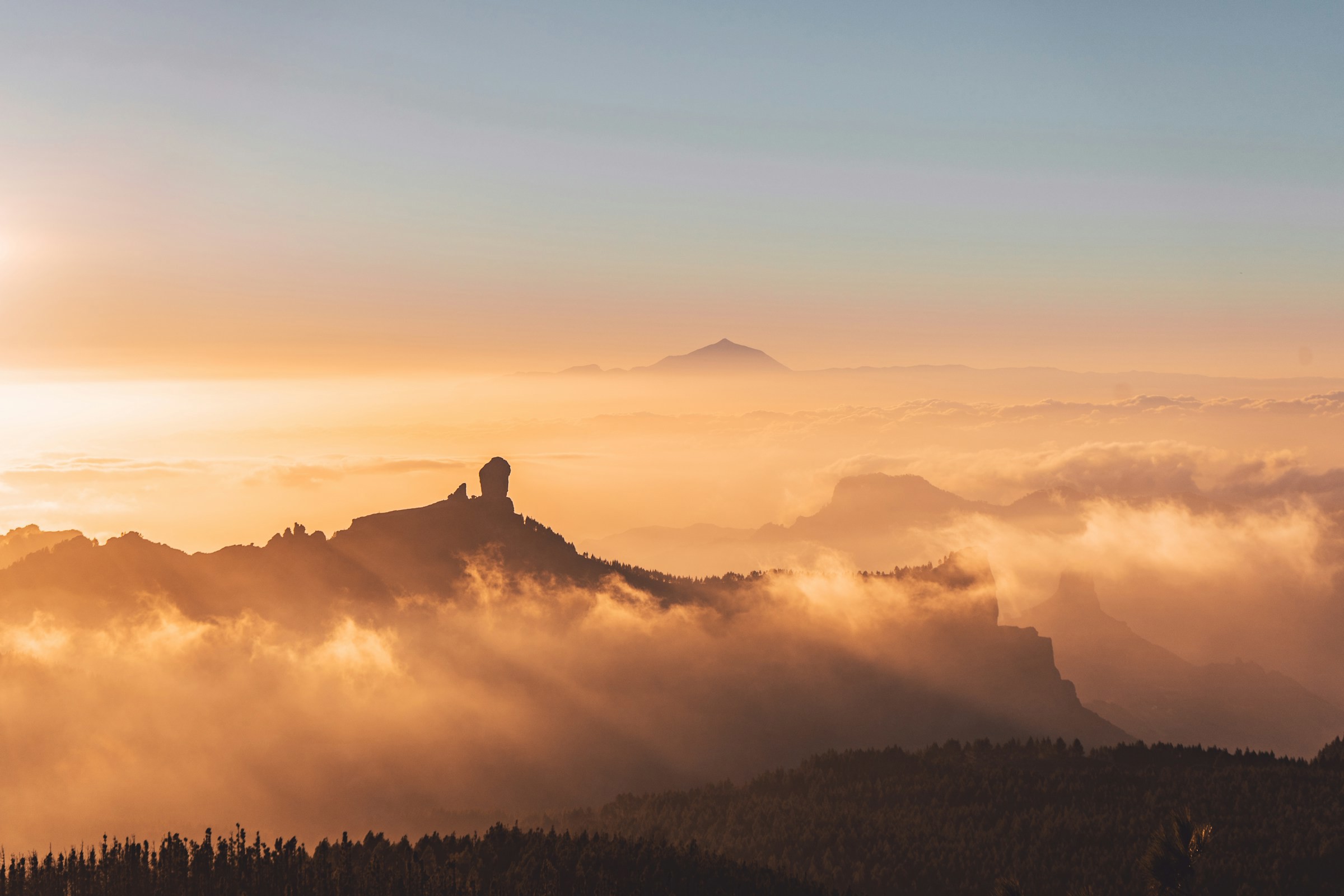 Sunrise at mountain top with clouds around