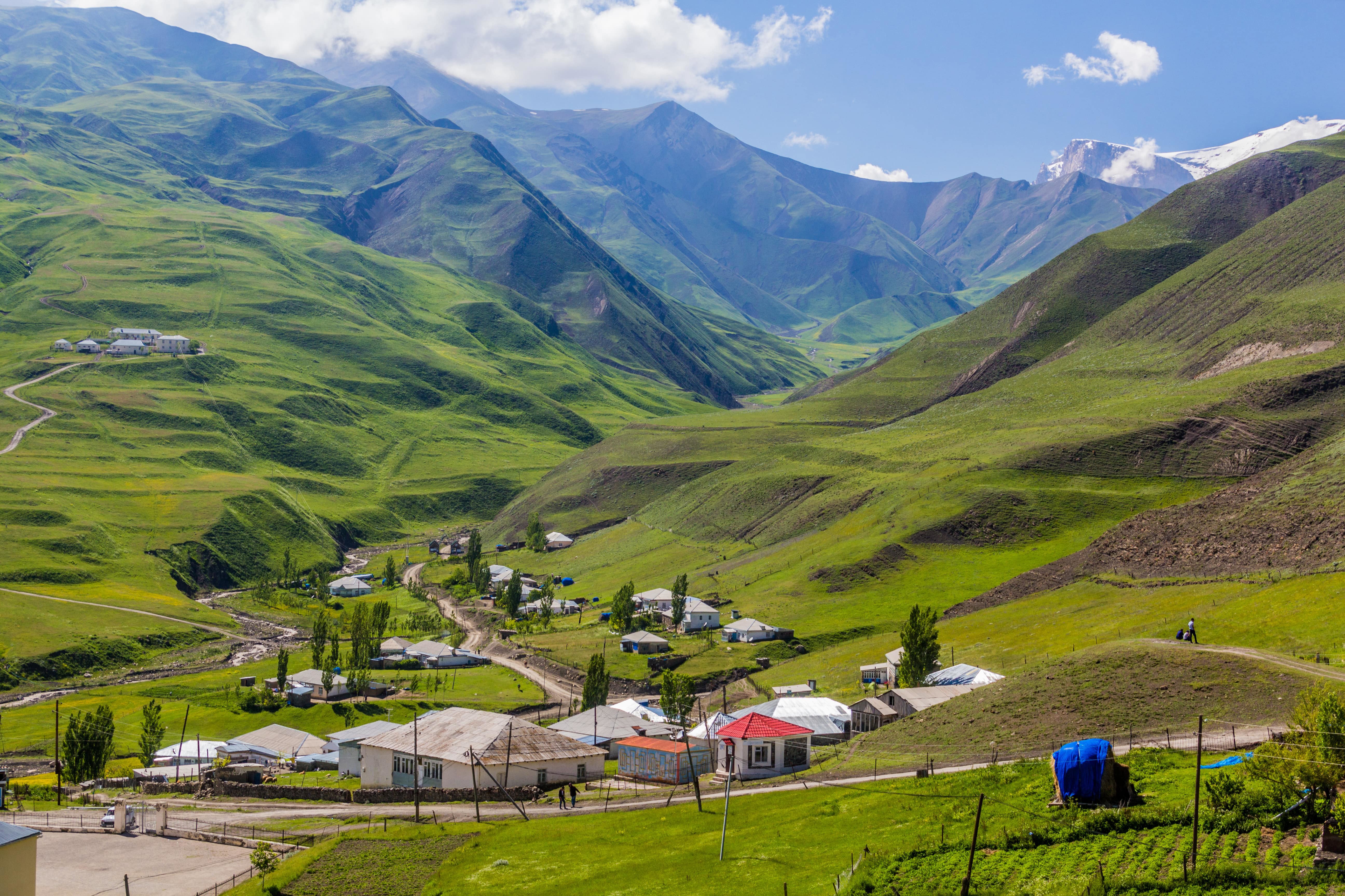 Beautiful nature up in the mountains with green plains and a village in the middle in northern Azerbaijan