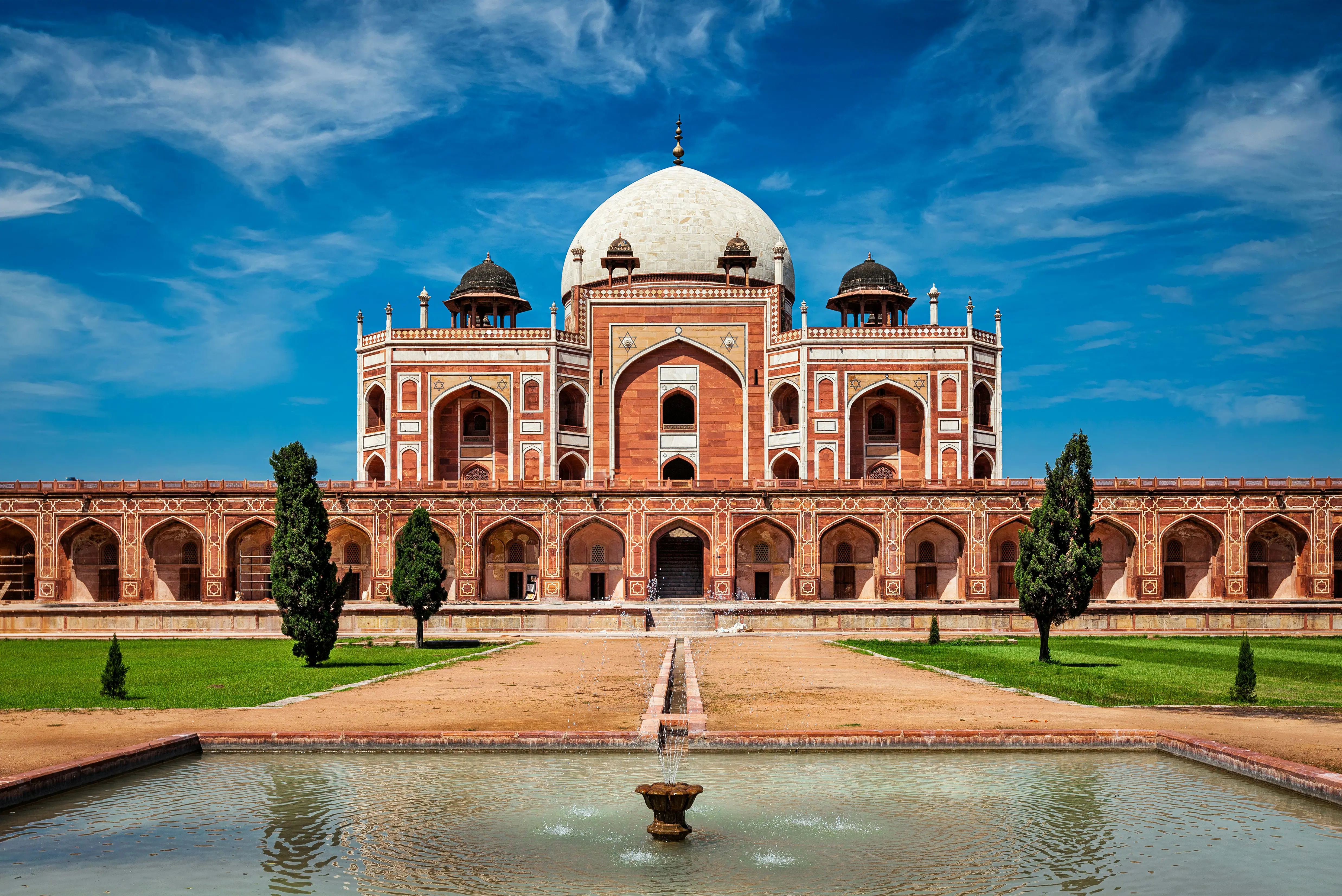 Resa till Delhi - Humayuns mausoleum i Delhi, Indien, en praktfull röd sandsten och marmorstruktur under en klarblå himmel.