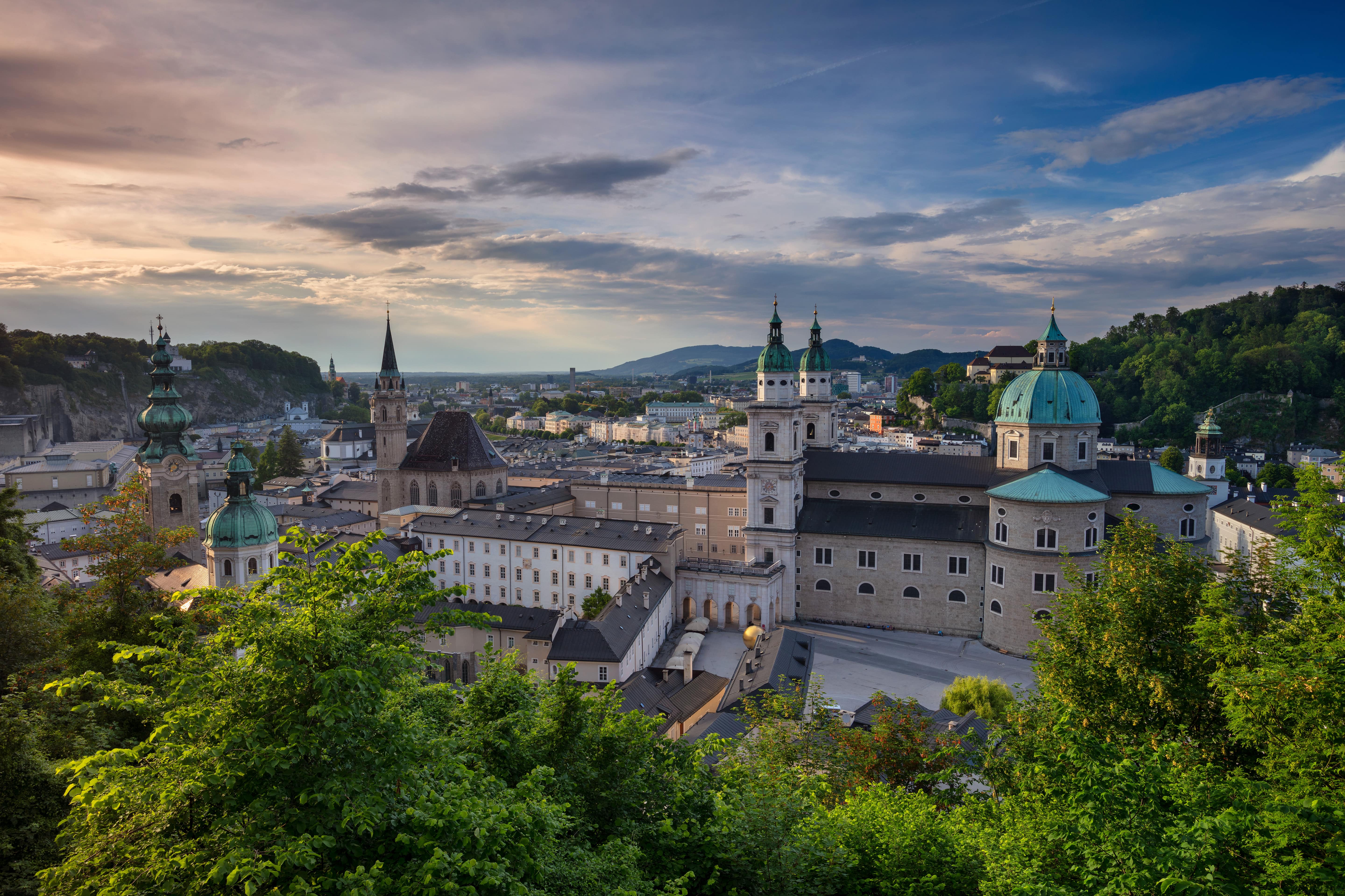 Travel to Salzburg - Sunset over Salzburg's old town with beautiful older buildings and greenery around it