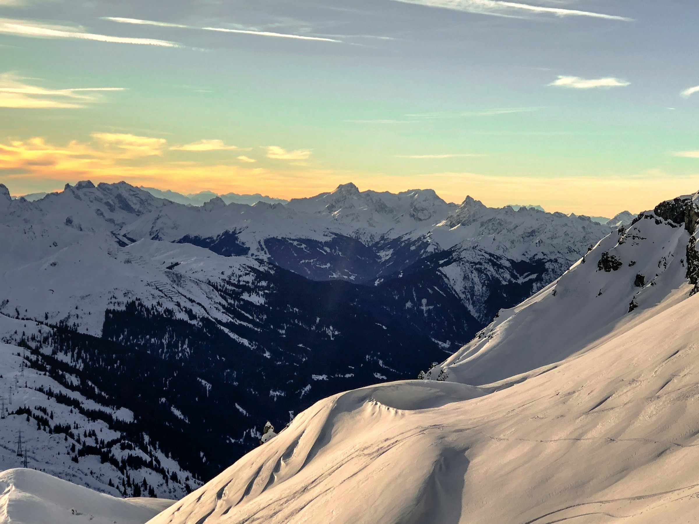 Sunset over snow-capped mountain peaks in St. Anton, Austria