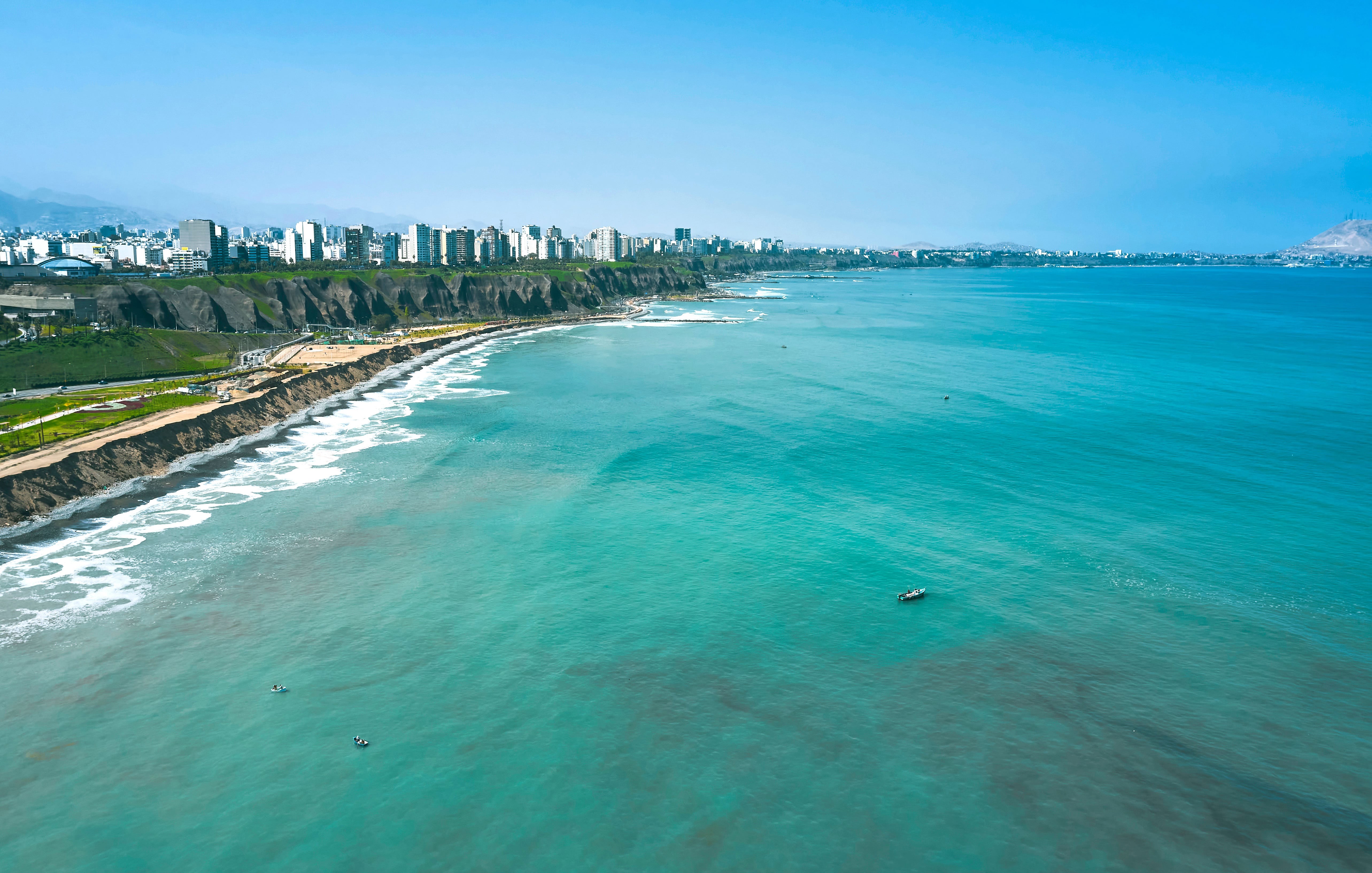 Turquoise blue sea meets a lush coastline on the outskirts of Lima in Peru.