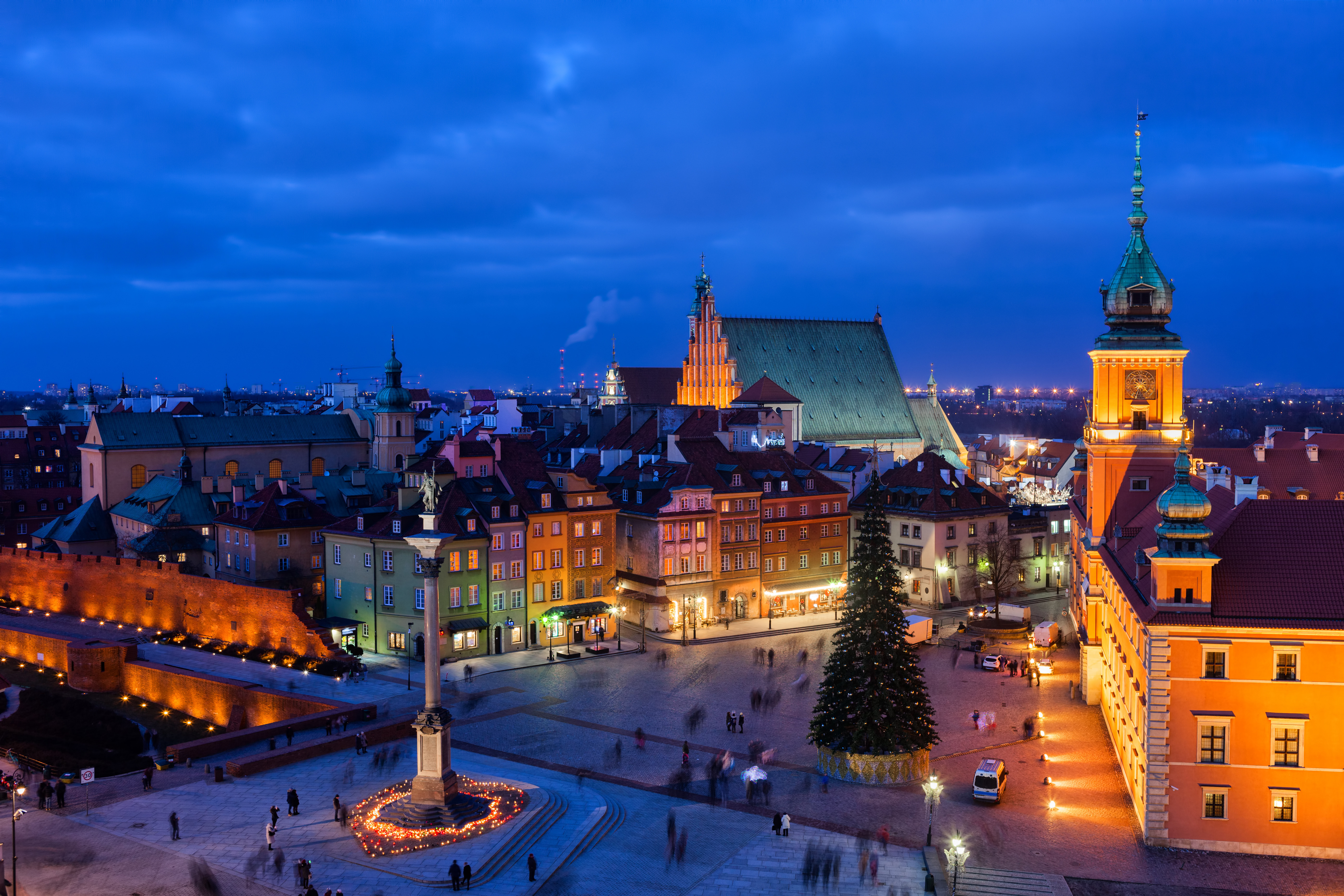 Travel to Warsaw - illuminated city at night with traditional European buildings and statues