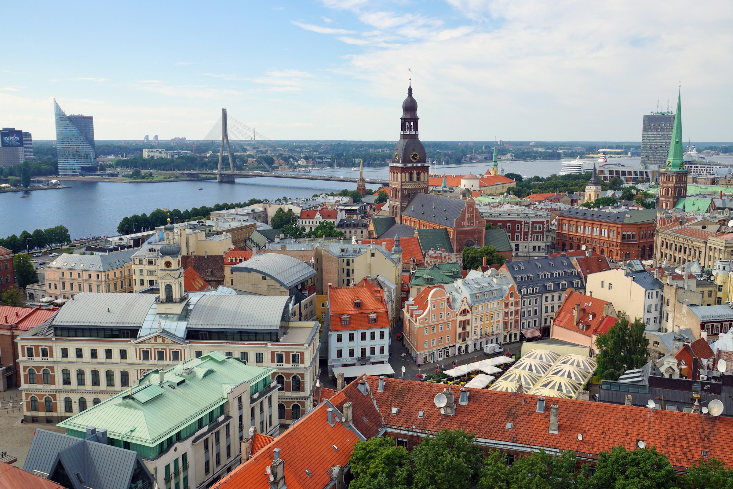 Utsikt över Riga stad i Lettland med äldre byggnader och klocktorn och vatten med broar över i bakgrunden