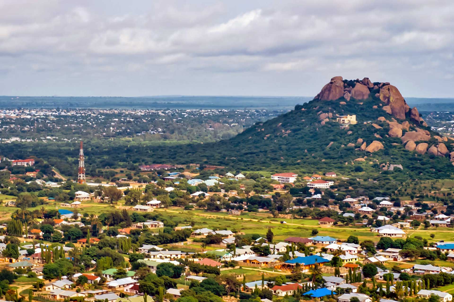 Travel to Dodoma - View from above of Tanzania's capital with greenery all around and mountains and plains in the background