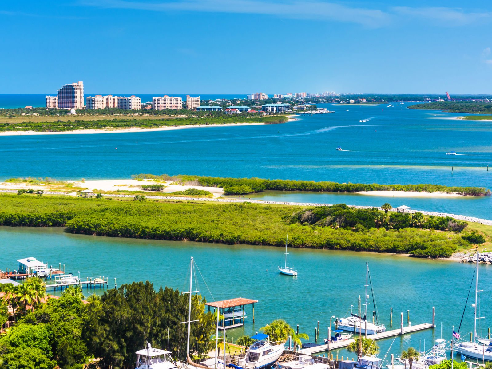 blue sea with greenery, harbor and city in the background in Florida