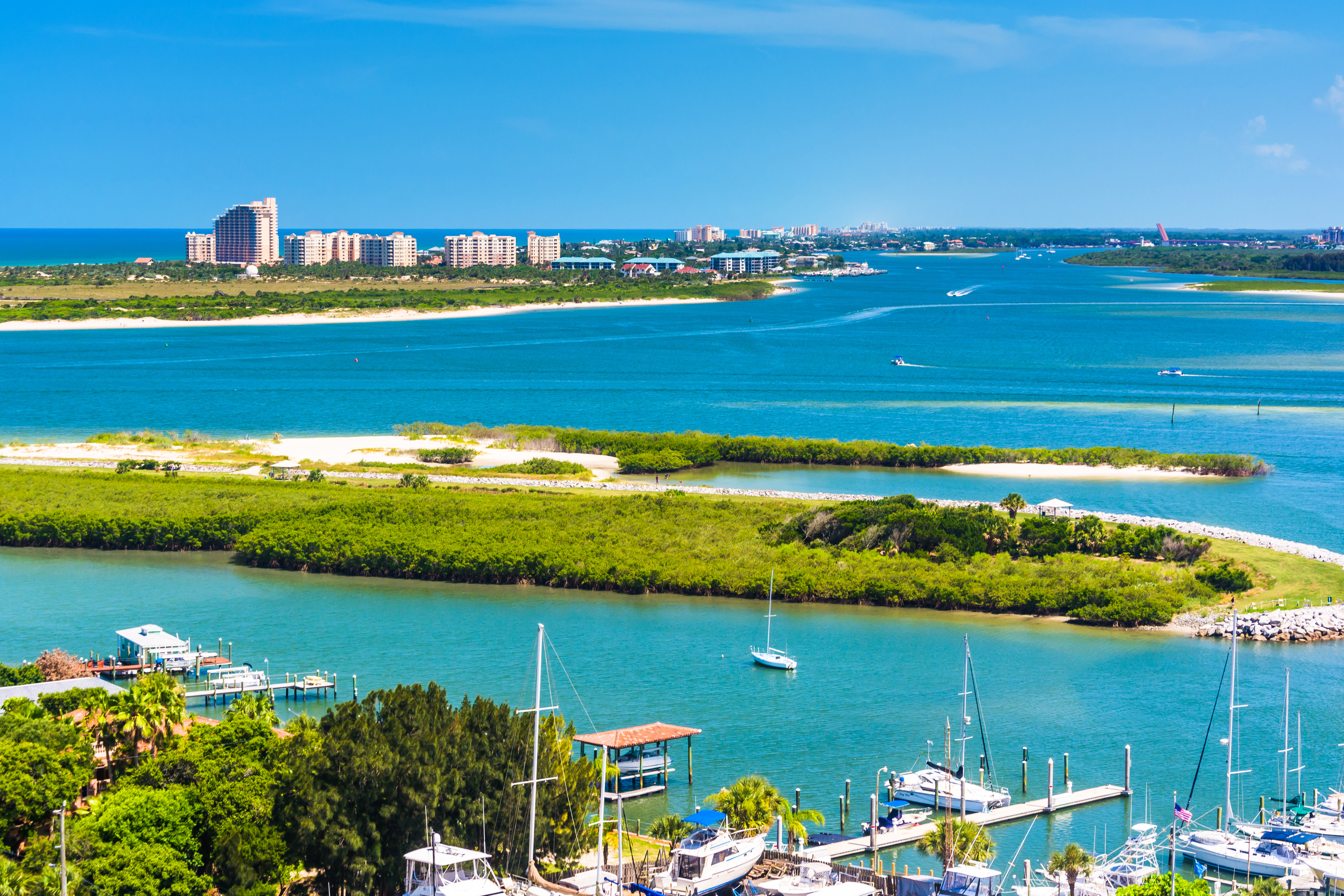 blue sea with greenery, harbor and city in the background in Florida