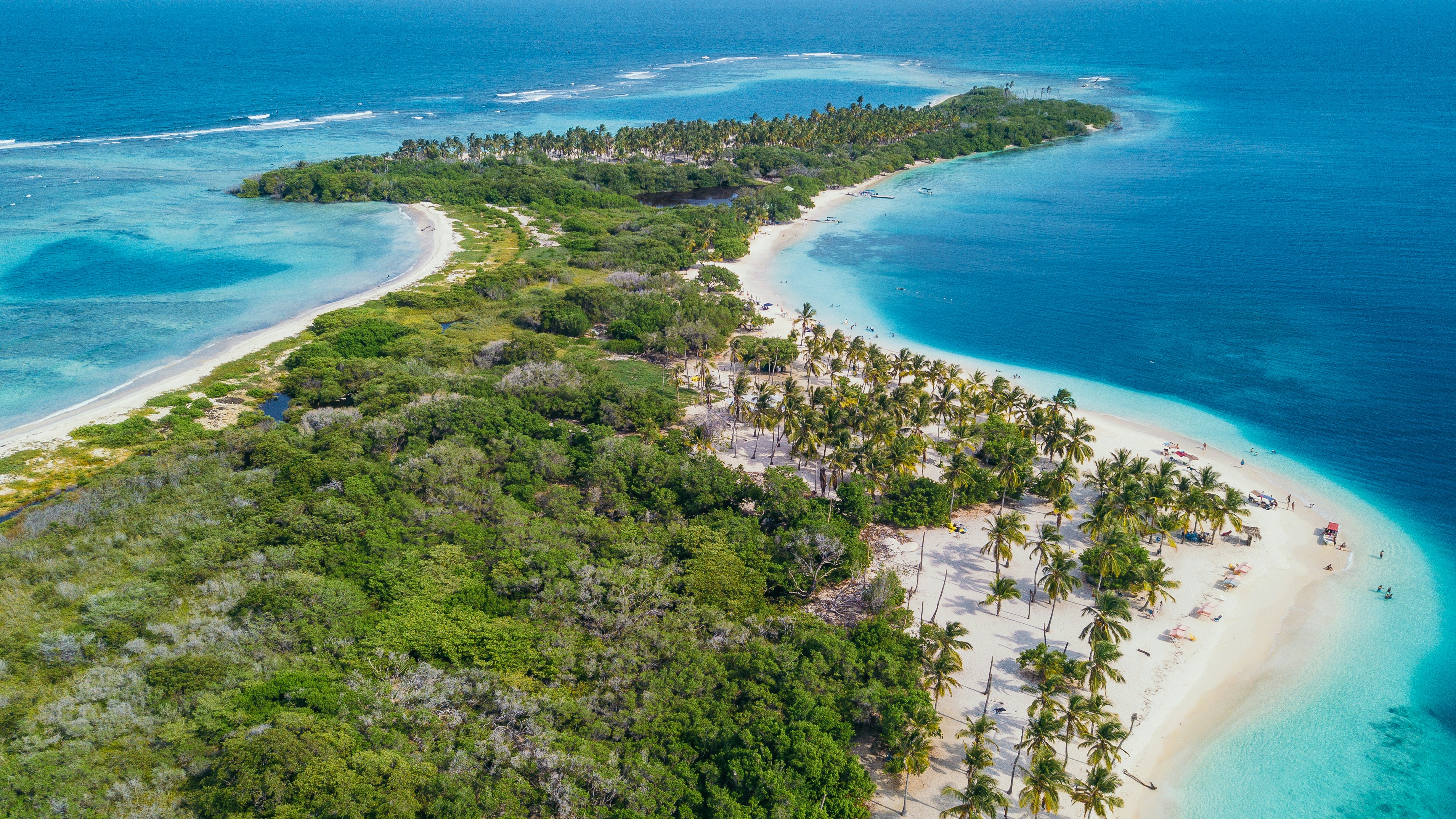 Flygbild av Venezuela med kristallklart vatten, vita sandstränder och prunkande gröna palmer perfekt för semesterresor.